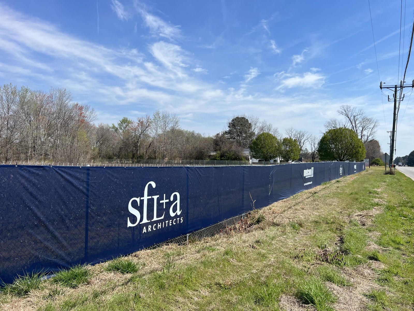 SFL+A Architects 9 oz printed mesh construction fence banner along roadside