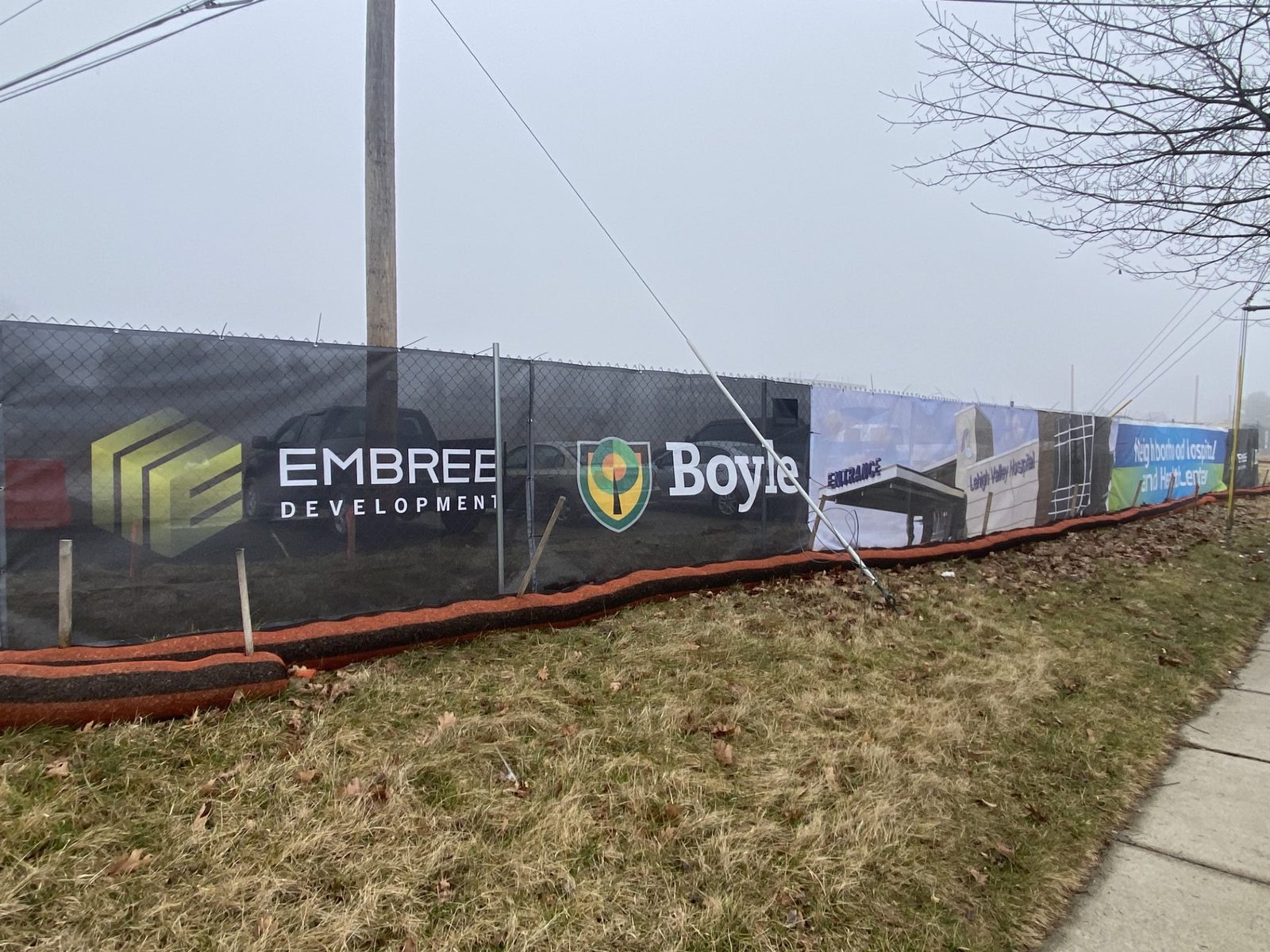 Embree Development and Boyle printed construction fence banner with project rendering