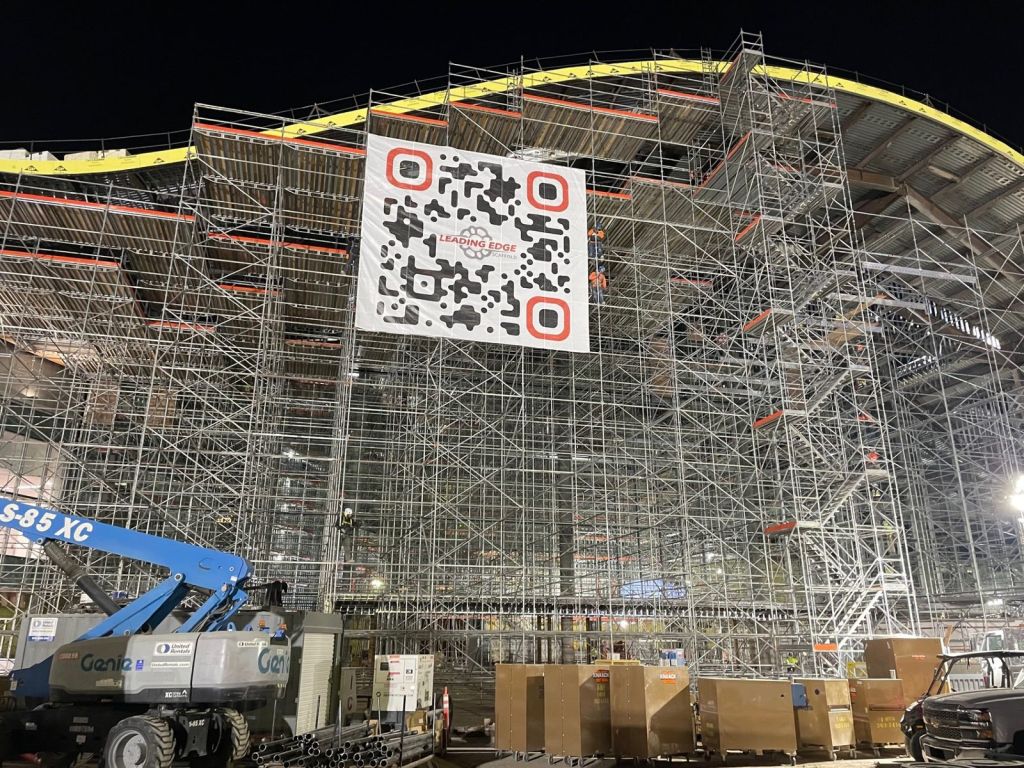 Oversized Leading Edge QR code banner on stadium scaffolding at night