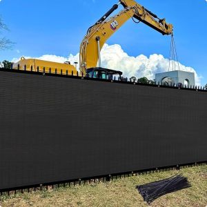 Plain black mesh privacy windscreen on a construction site fence