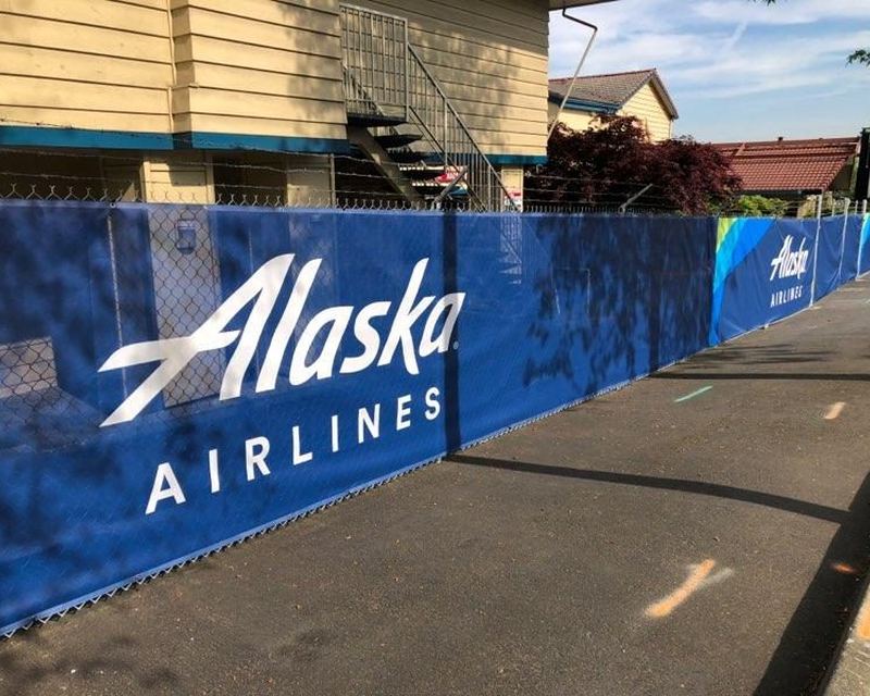 Full-color printed construction fence wrap on a jobsite fence