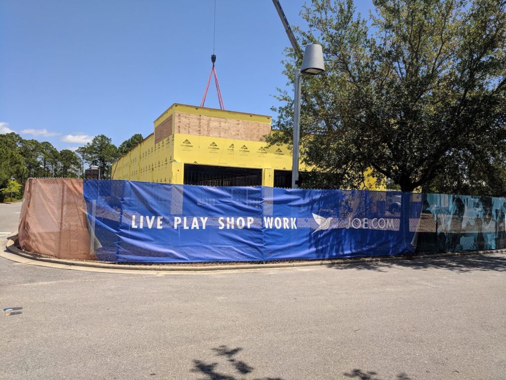 Full-color St. Joe Live Play Shop Work printed fence wrap around a construction site
