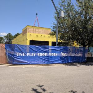 Full-color St. Joe Live Play Shop Work printed fence wrap around a construction site
